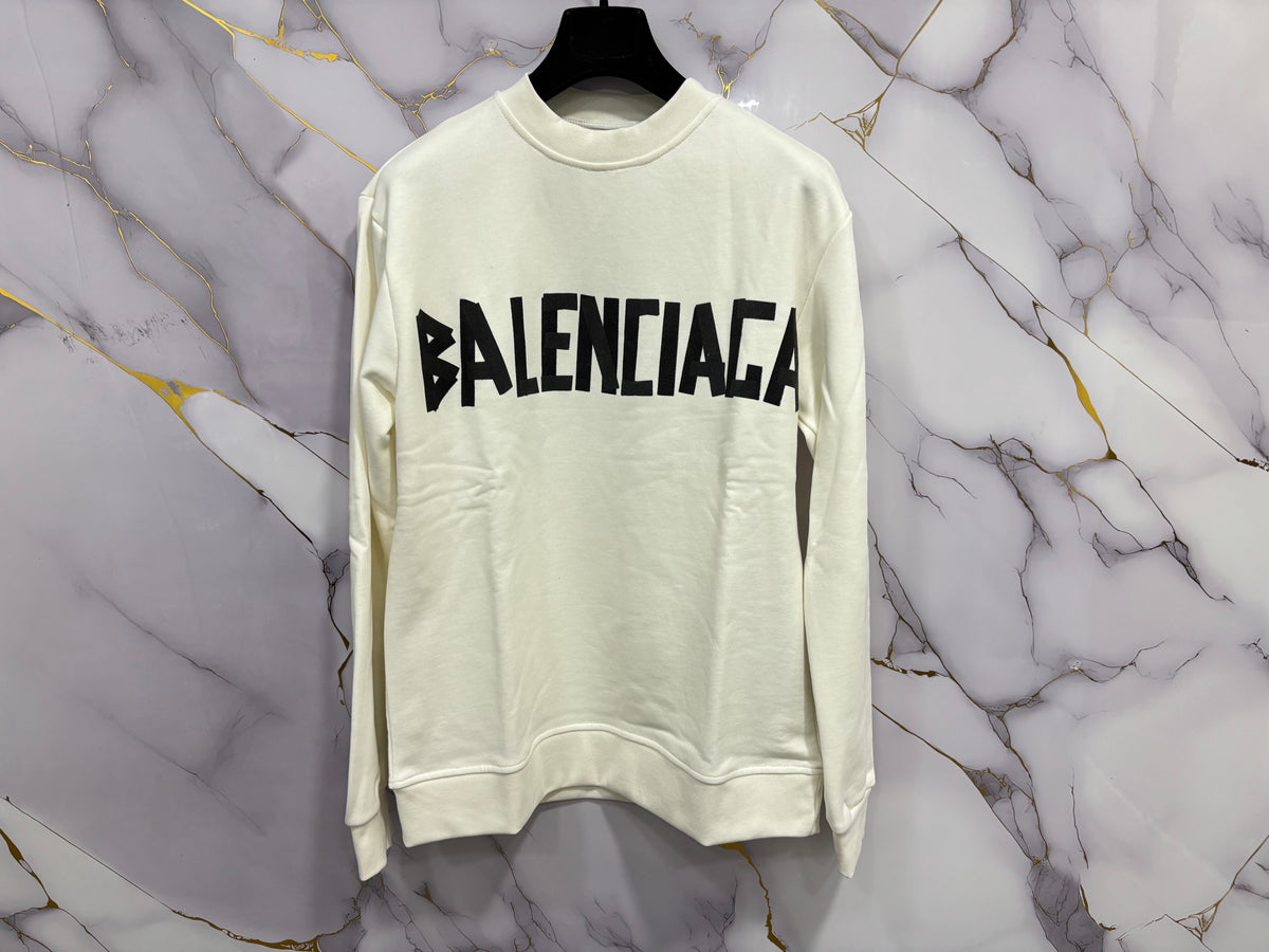 FELPA BALENCIAGA SCOCH displayed on a marble background, showcasing the stylish design of the sweatshirt.