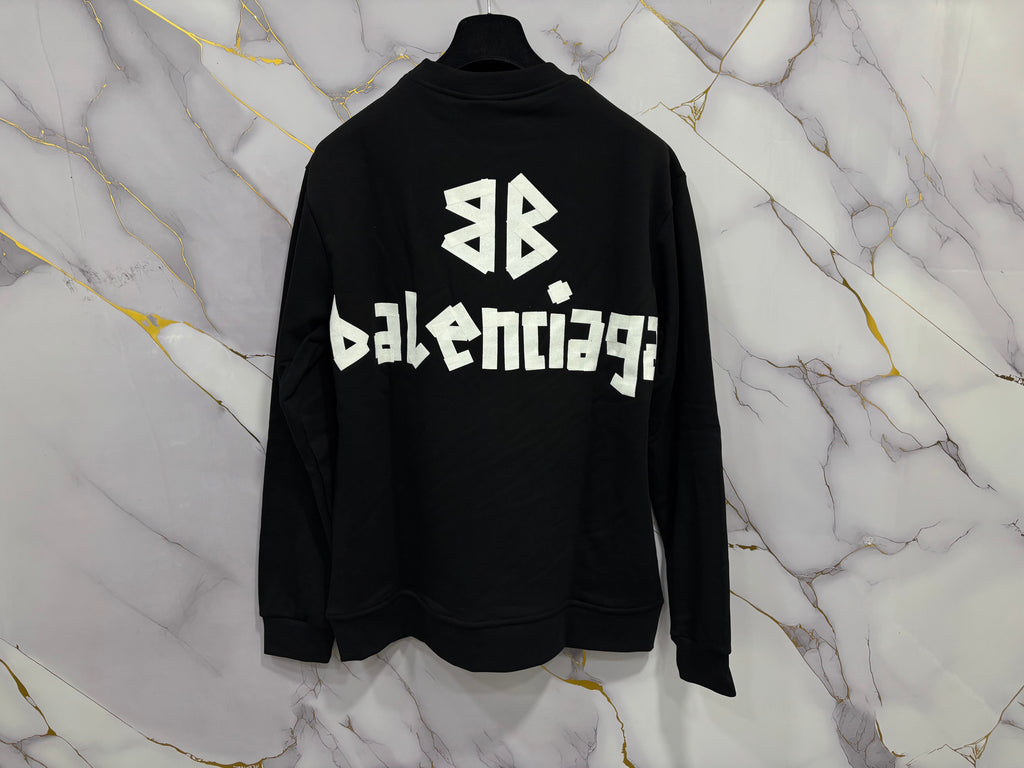 FELPA BALENCIAGA SCOCH displayed on a marble background, showcasing the iconic Balenciaga branding.