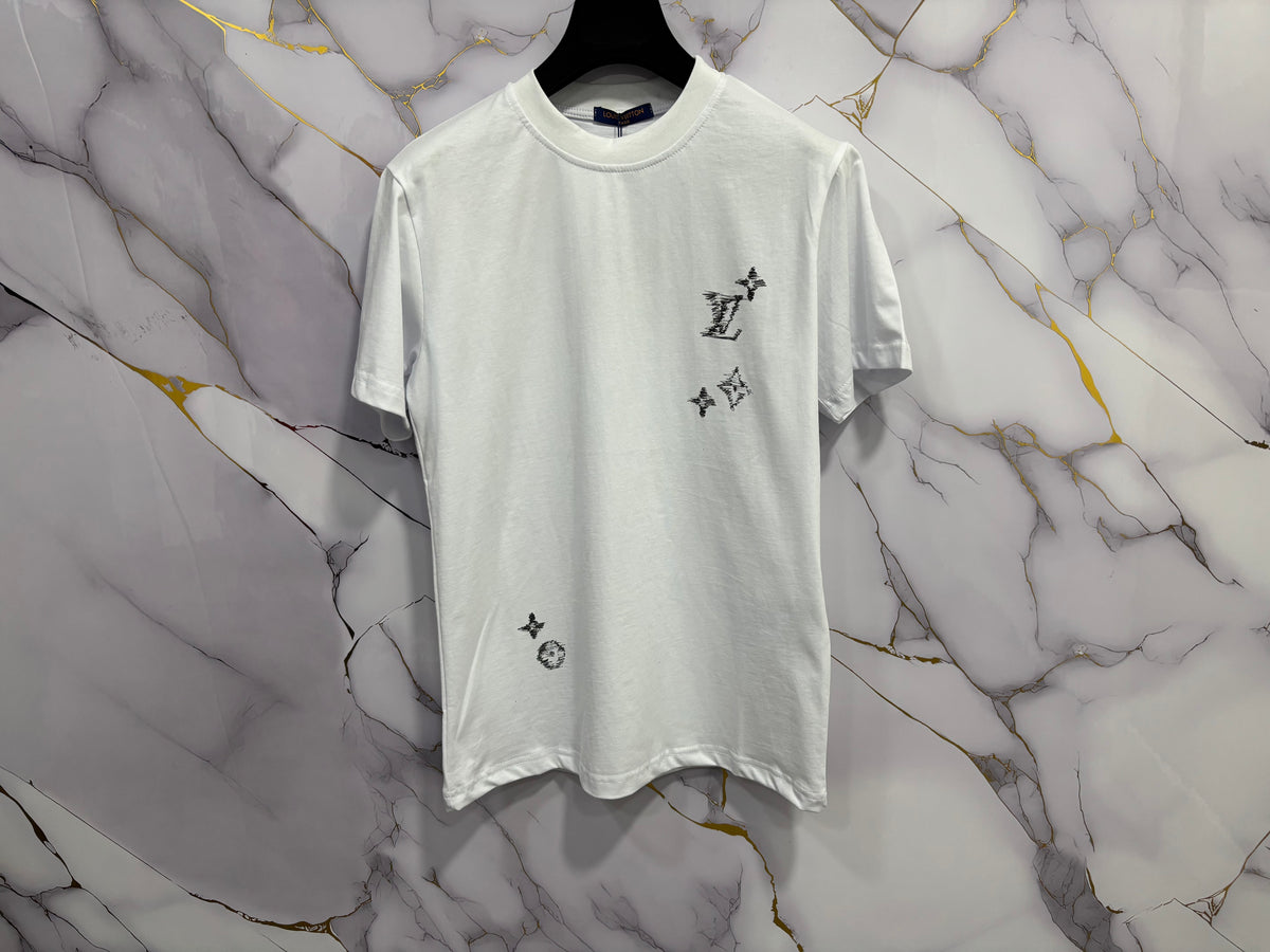 T-SHIRT LV (RICAMO) displayed on hanger against a stylish marble background.