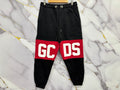 PANTALONE GCDS featuring bold red and black design, perfect for casual style and comfort.