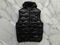 Stylish SMANICATO BALUER black padded vest on a marble background, perfect for layering in any season.