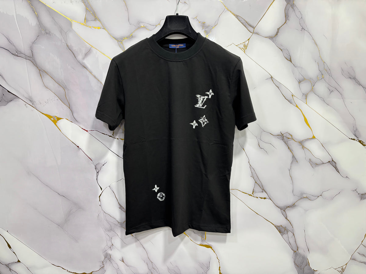 T-SHIRT LV (RICAMO) displayed on a hanger against a marble background showcasing its unique design.